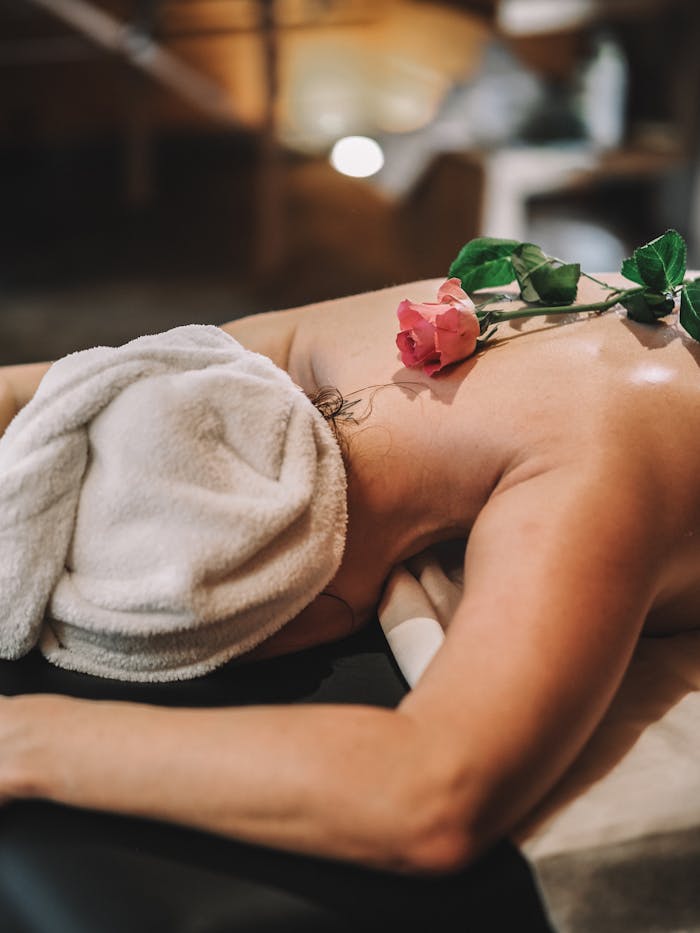 A woman getting a massage with rose petals